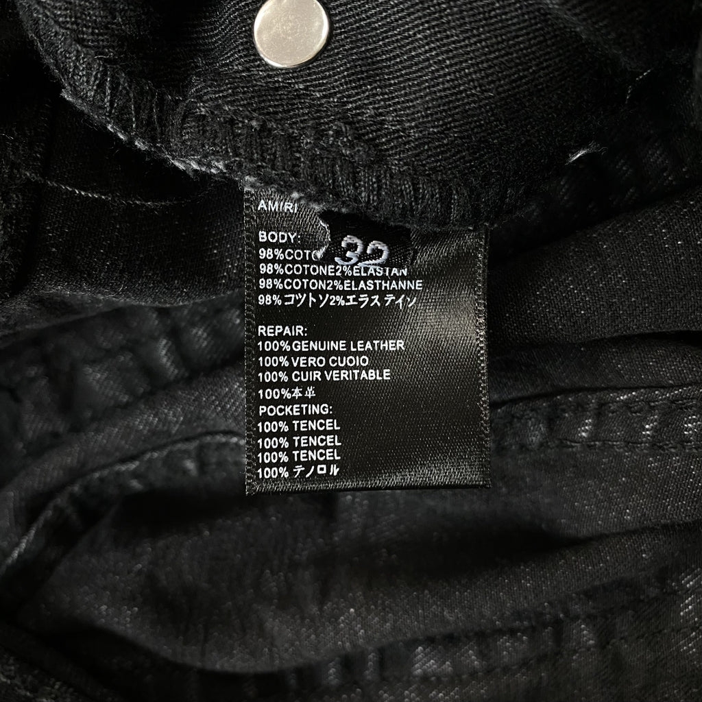 AMIRI VARSITY LOGO REPAIR JEANS