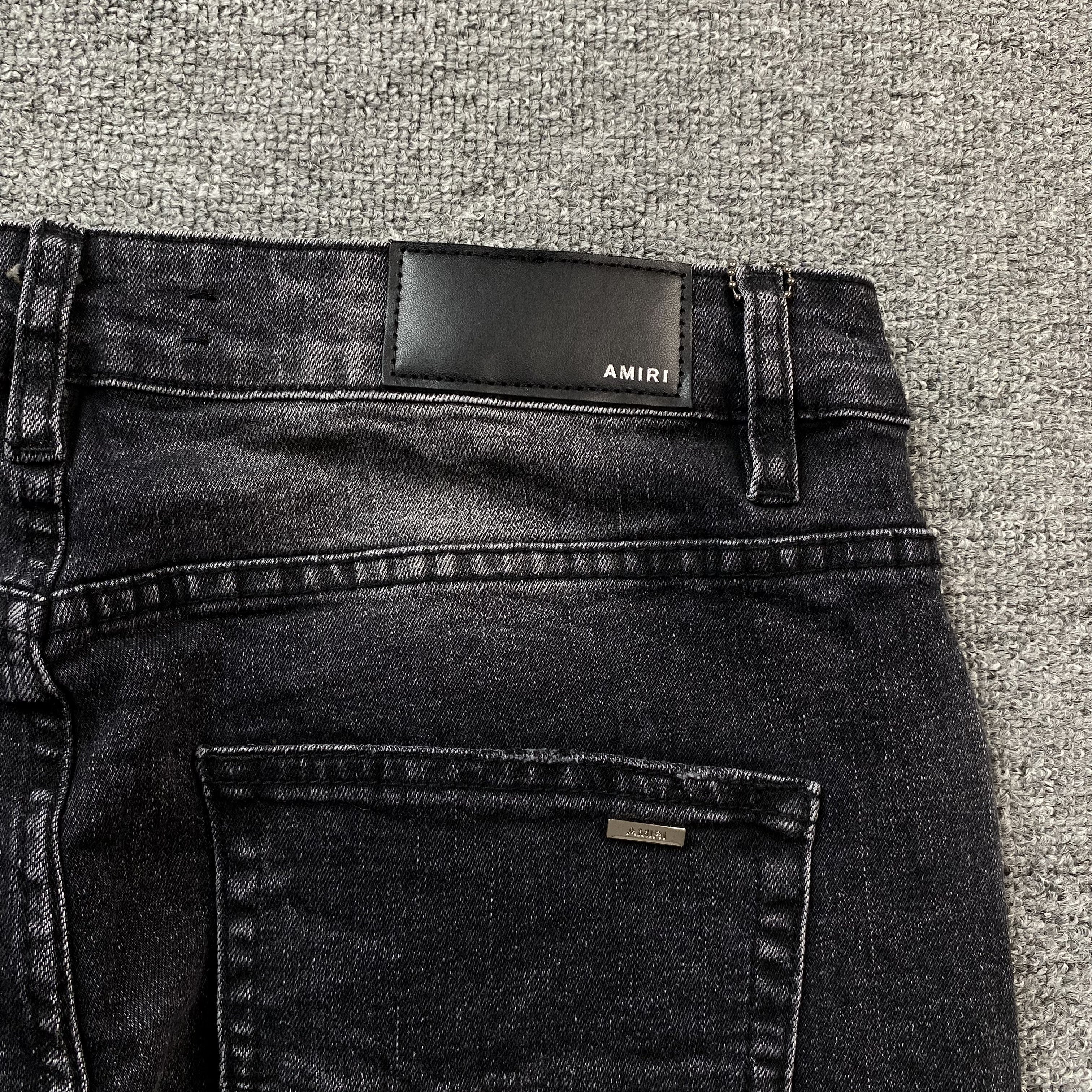AMIRI VARSITY LOGO REPAIR JEANS